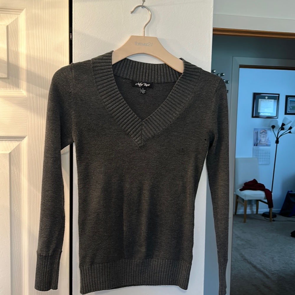 Gray sweater with V-neck.